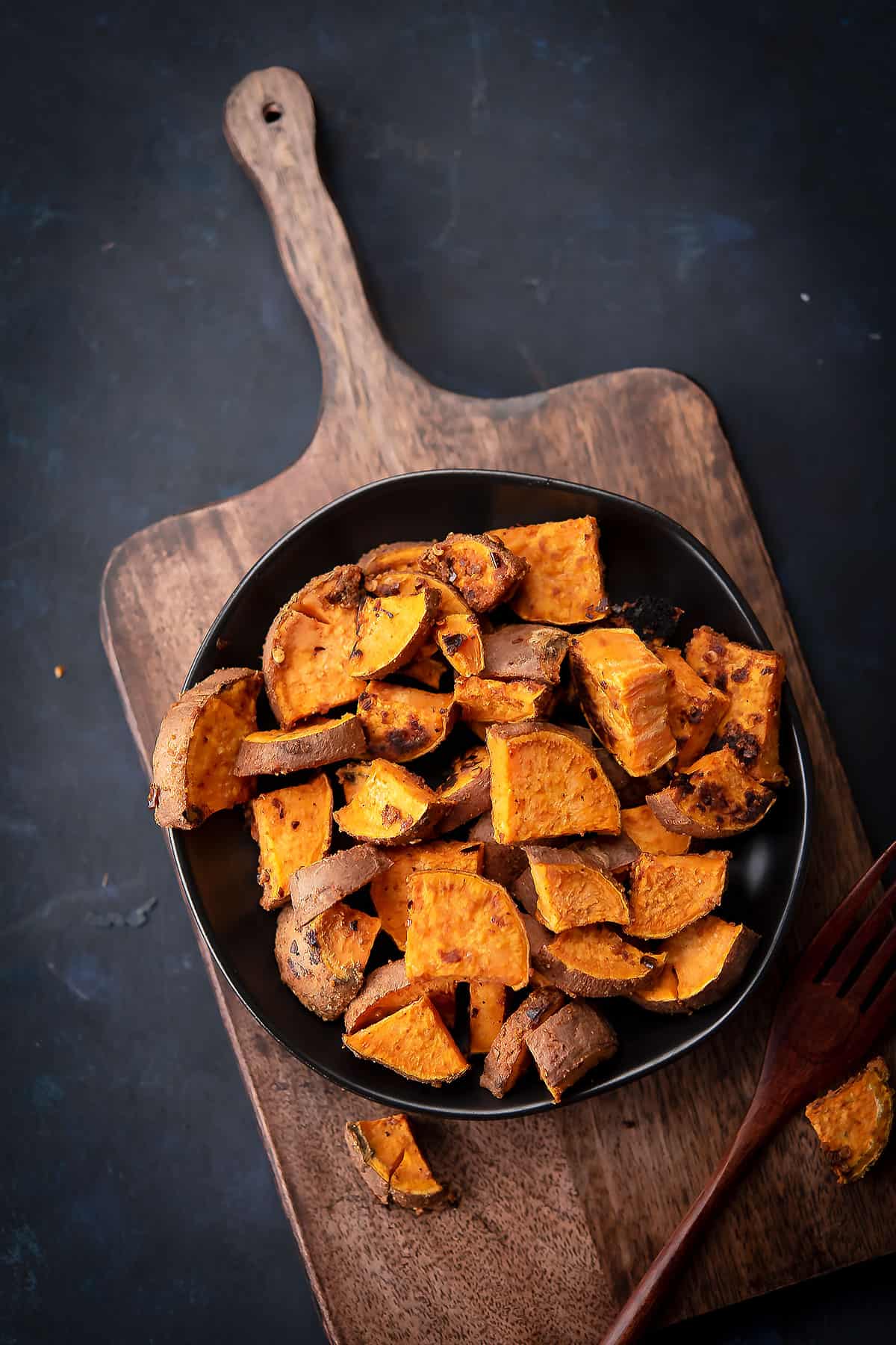 spicy roasted sweet potato placed in a black plate