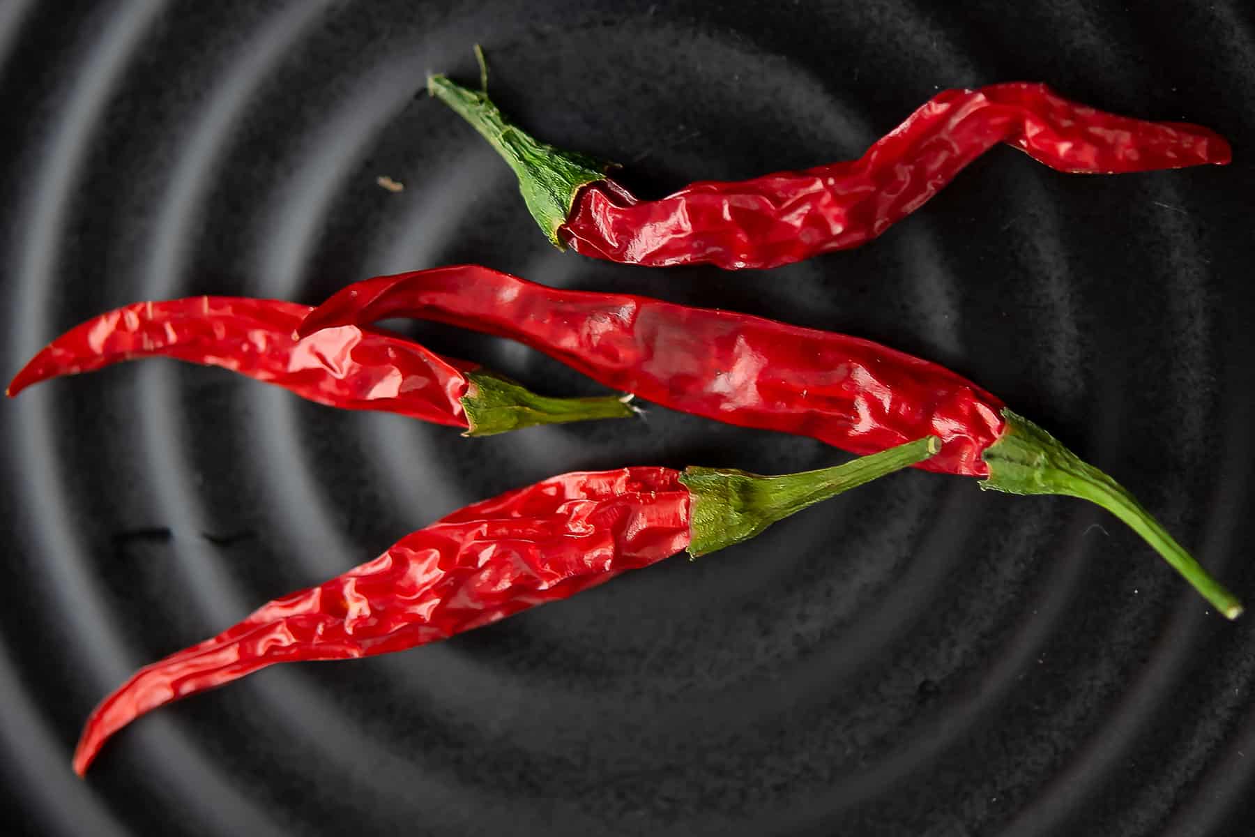 cayenne pepper is rich hot spicy ingredient placed in a black plate