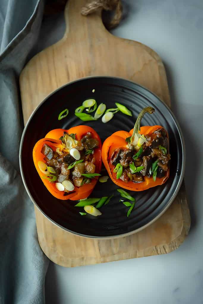eggplant stuffed peppers, served in a plate