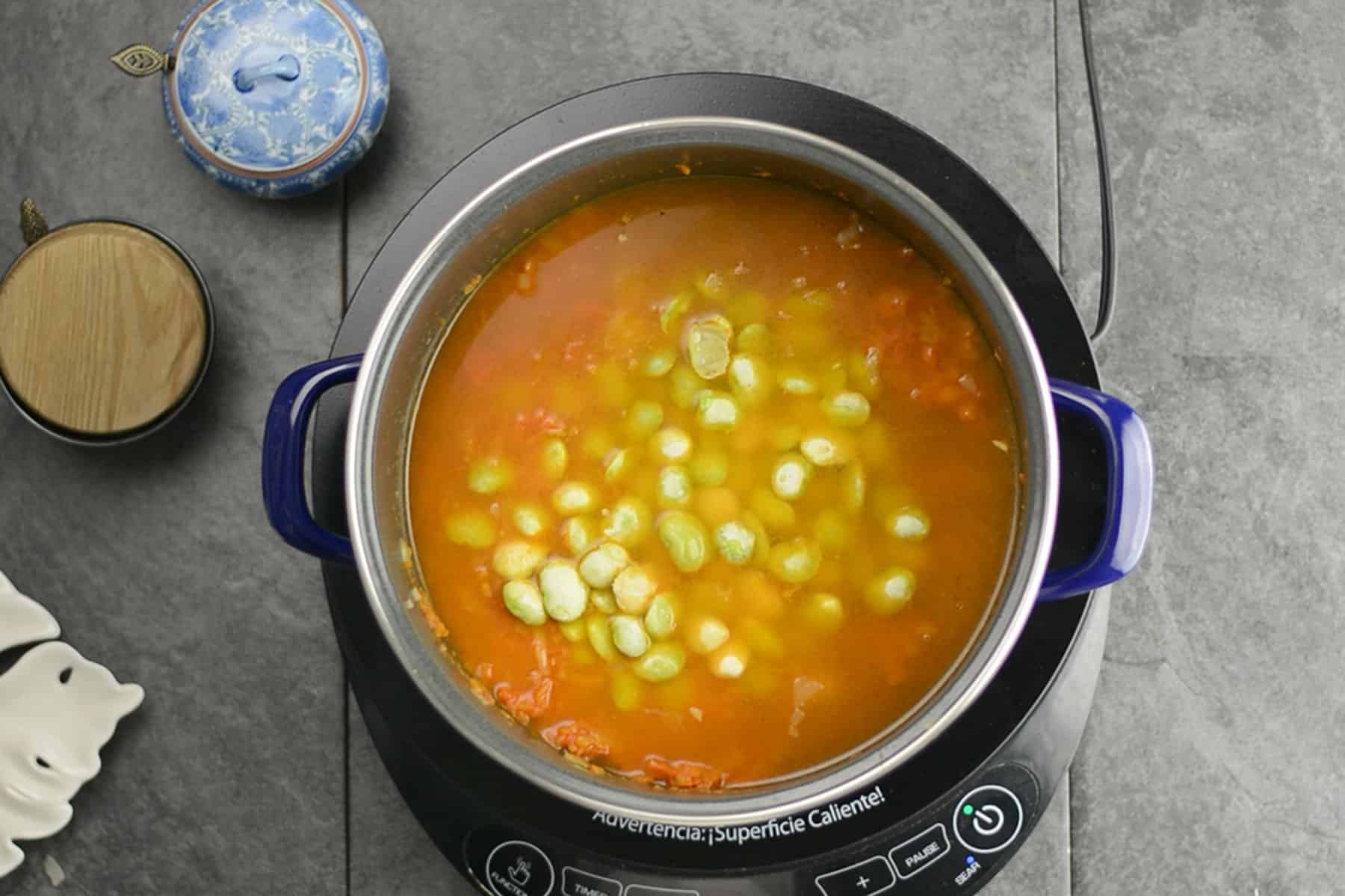 adding frozen lima beans for making the curry