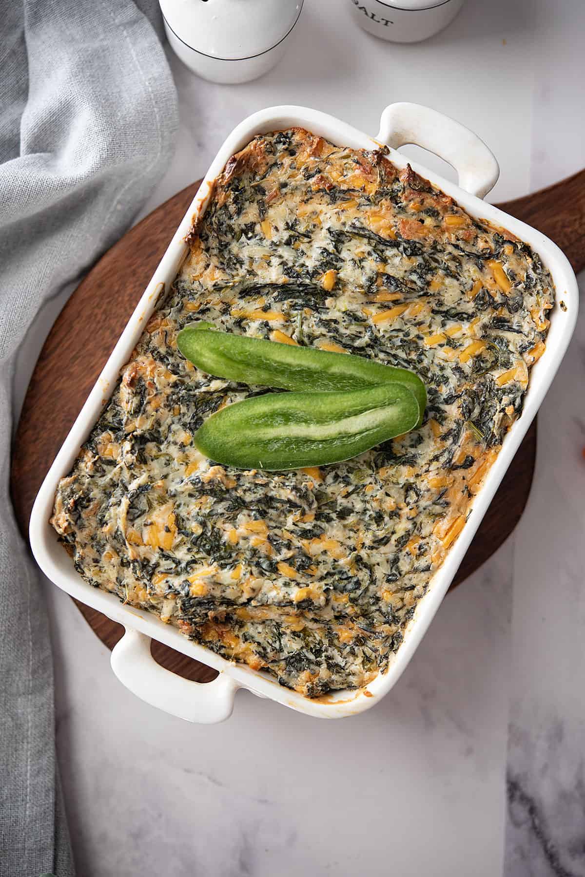 cheese, spicy, jalapeno spinach dip in a white deep dish