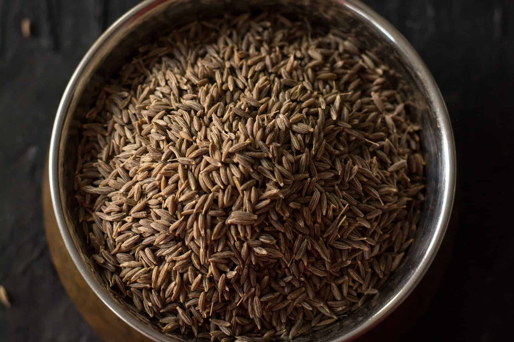 cumin seeds in a brass bowl
