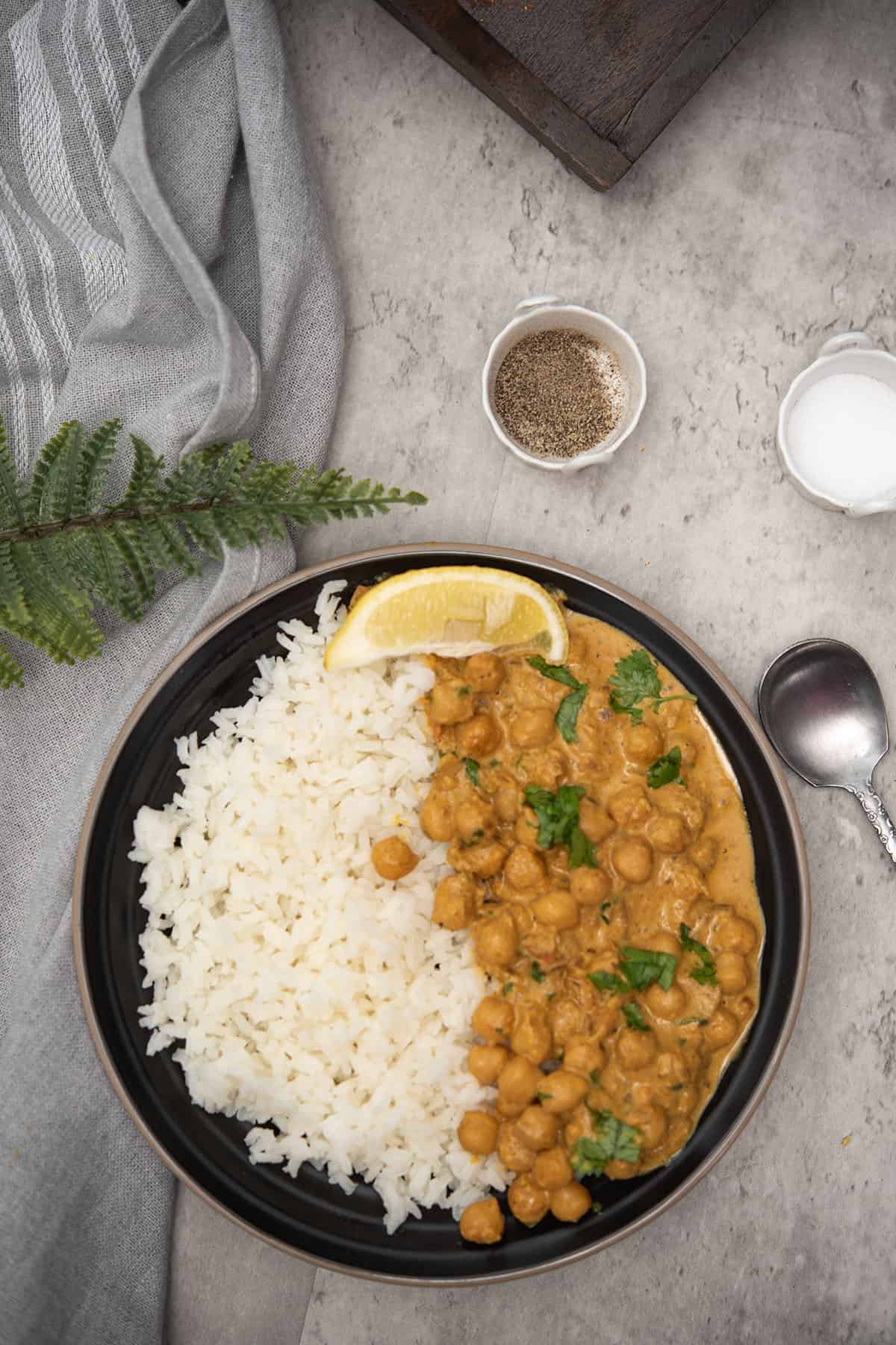 top view of almond milk curry in a black plate