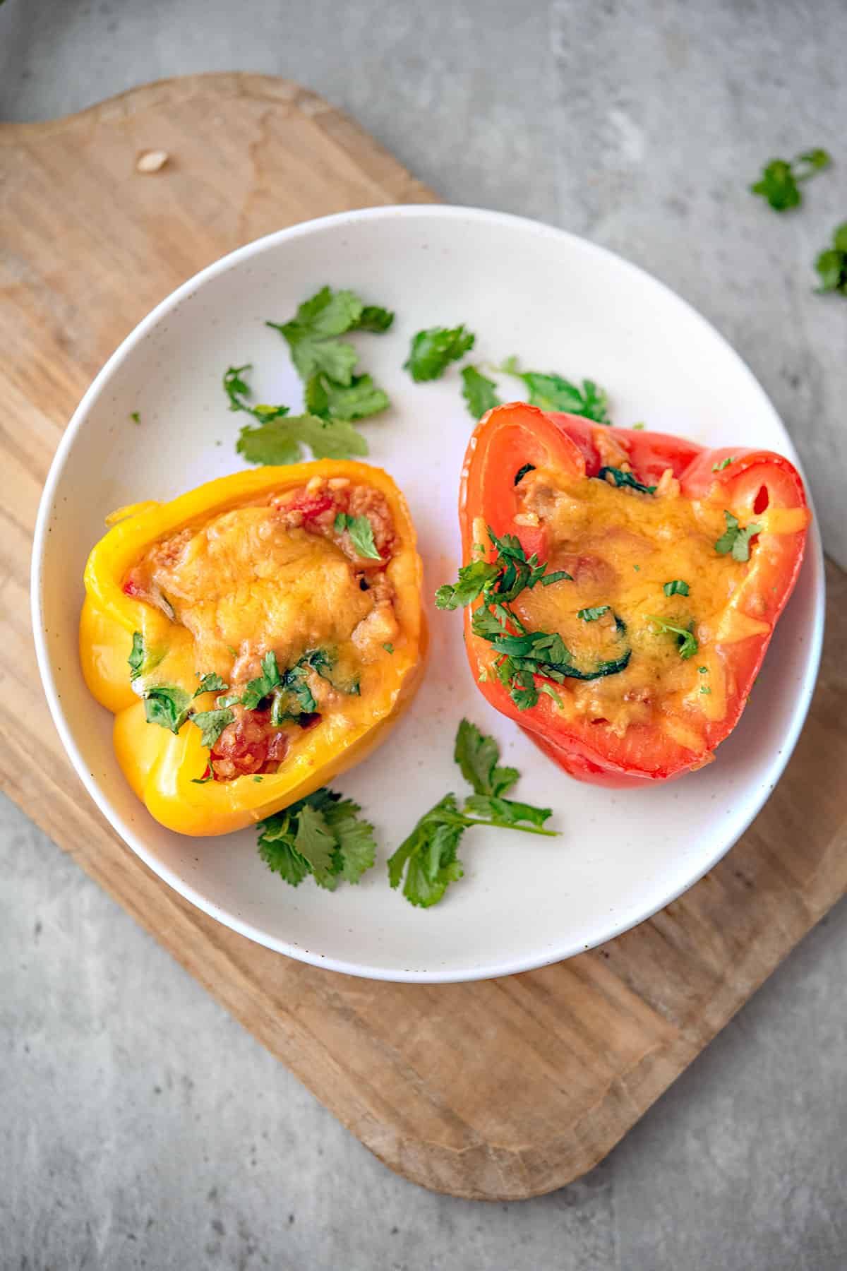 two turkey stuffed peppers are served in a white plate