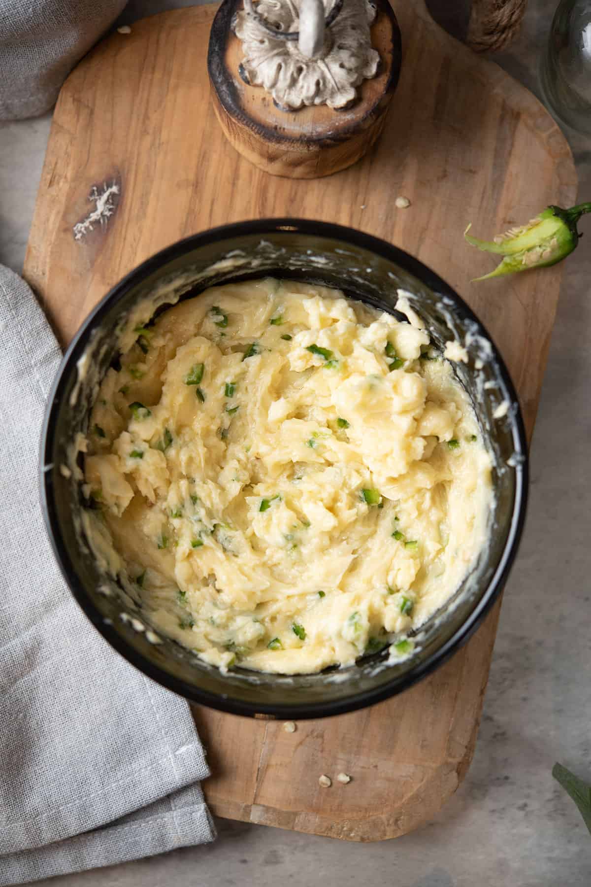 jalapeno butter ready to serve in a bowl and wooden tray