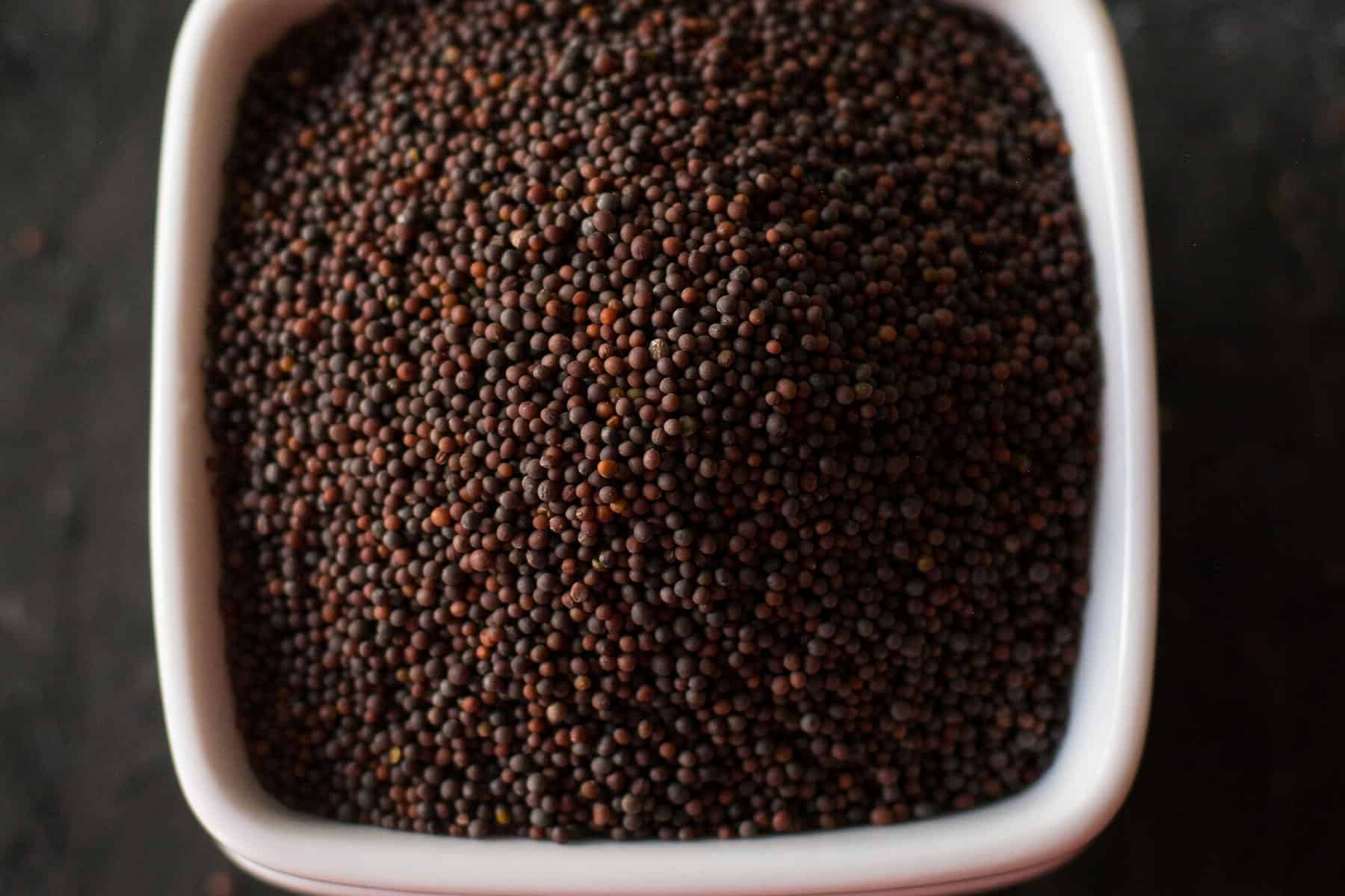 what spices in a curry is mustard seeds in a rectangle bowl 