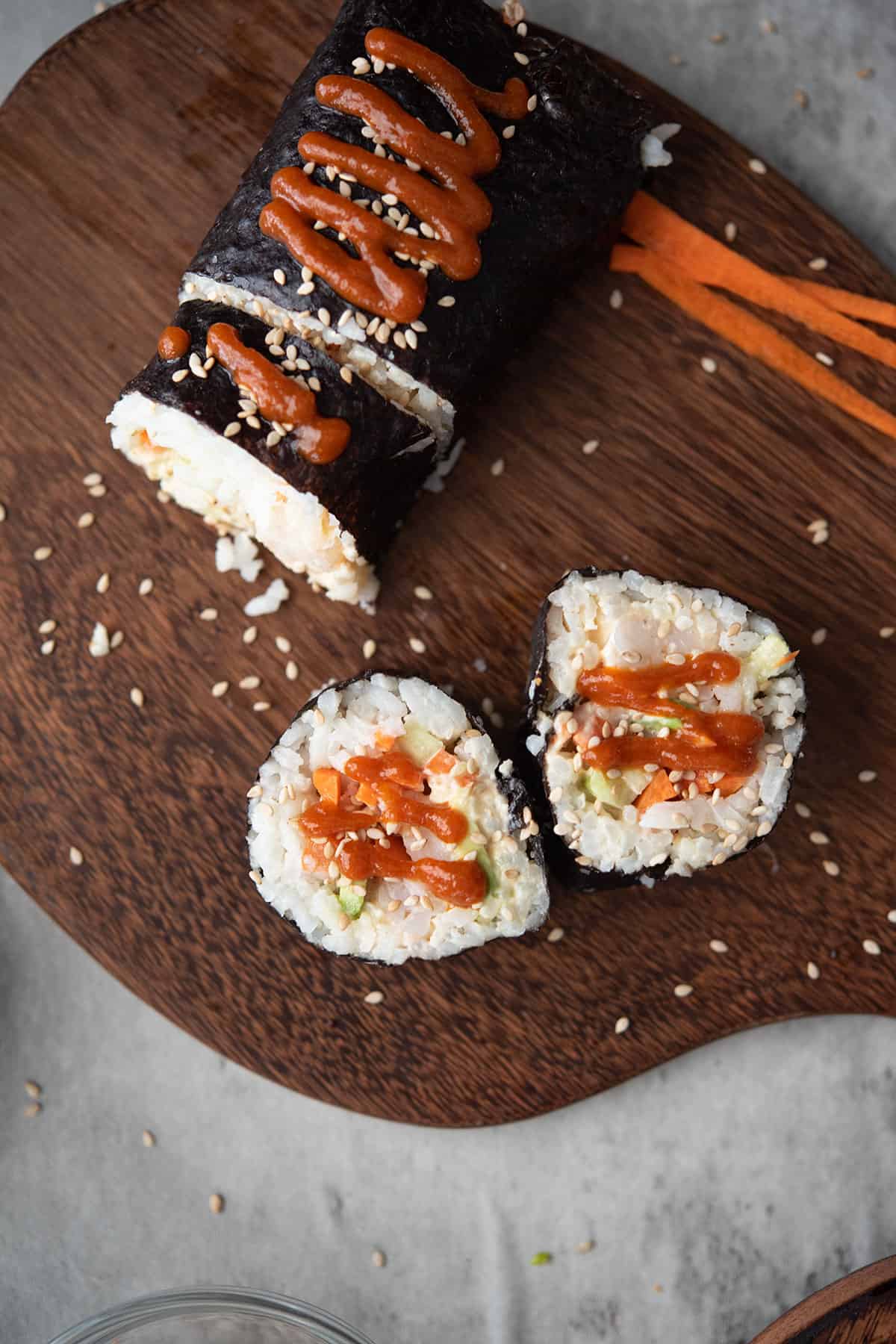sushi rolls placed in a wooden tray