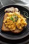 sriracha scrambled eggs served in a plate