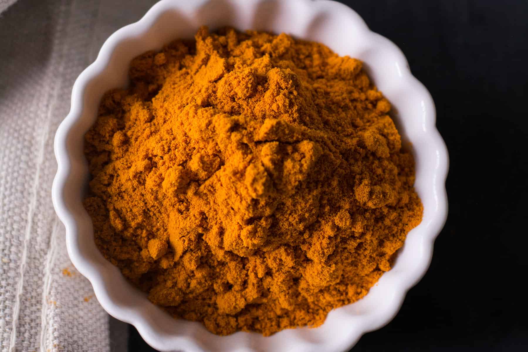 what spices in a curry? its turmeric in a white bowl