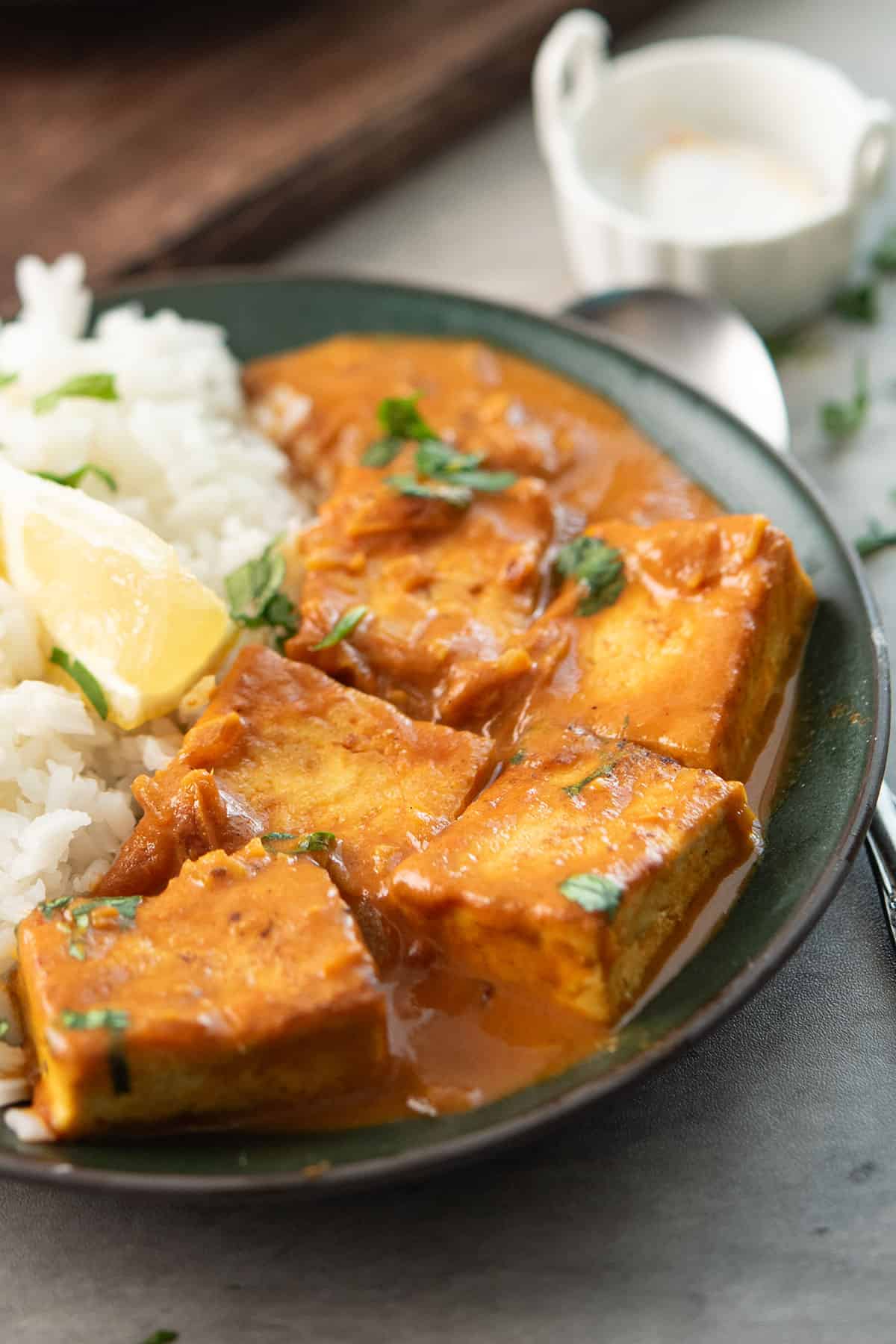 tofu curry sauce in the serving plate with cilantro garnish