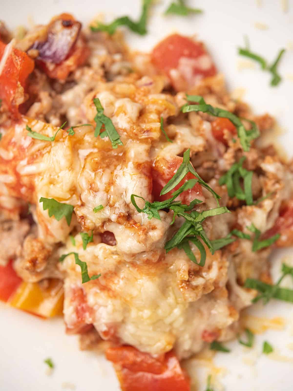 deconstructed stuffed pepper served in a plate with oozing cheese and chopped cilantro
