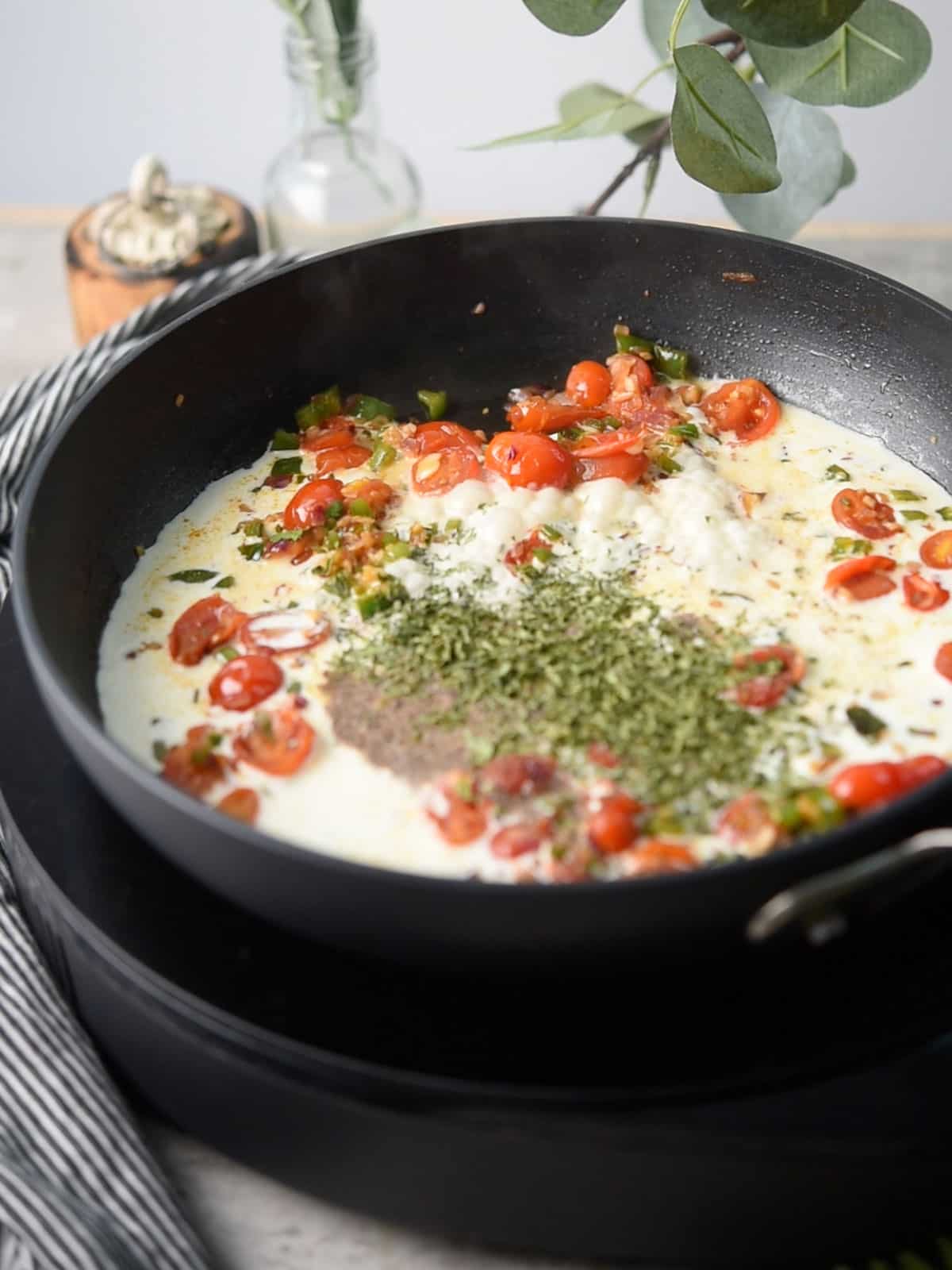 step:1 stirring in cream and herbs for making jalapeno spaghetti