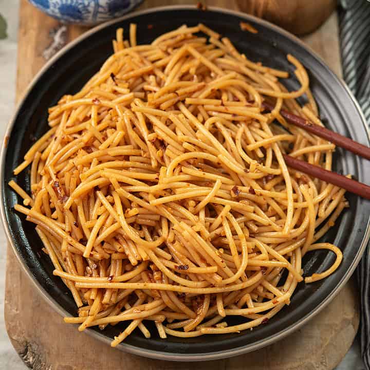 spicy garlic noodles served in a black plate