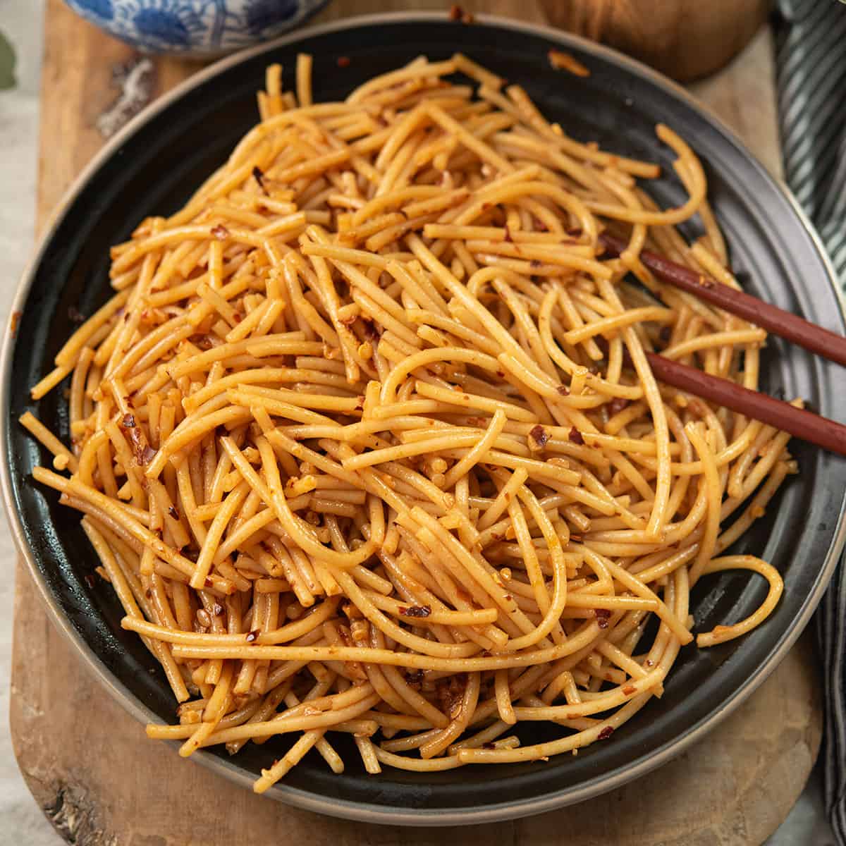 spicy garlic noodles served in a black plate