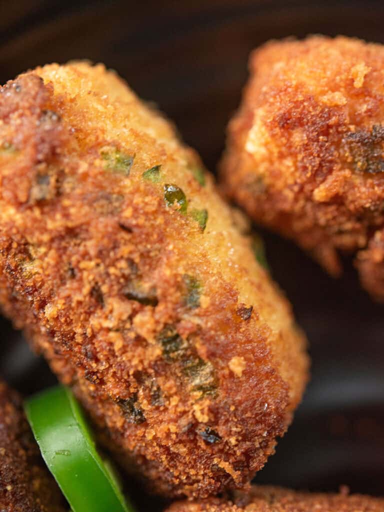 crunchy, crispy, drooling cheese sticks a close view with jalapeno pieces