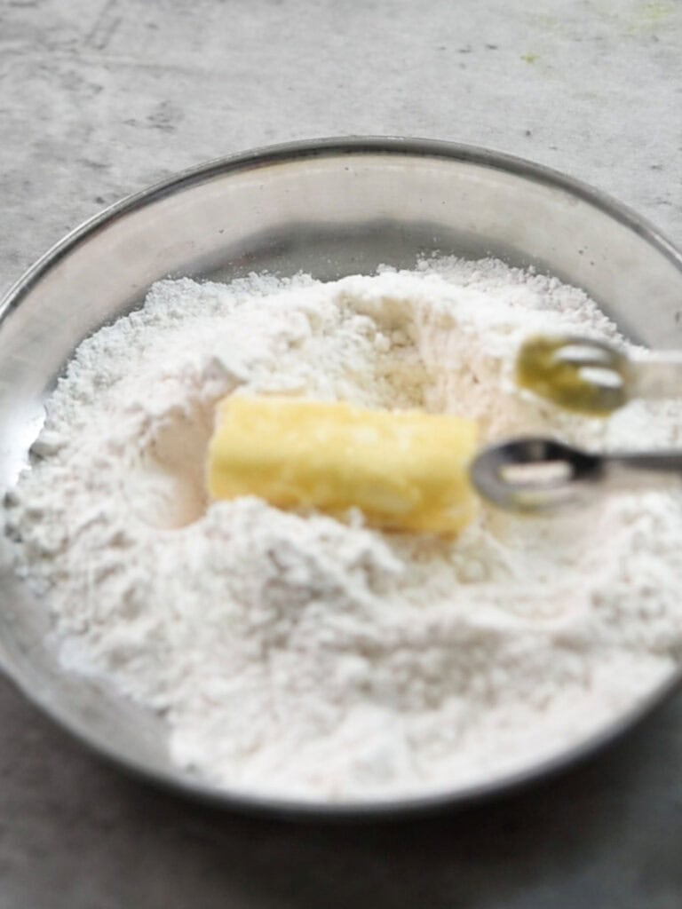 step 2 : tossing the cheese sticks into flour for making Jalapeno Cheese Sticks