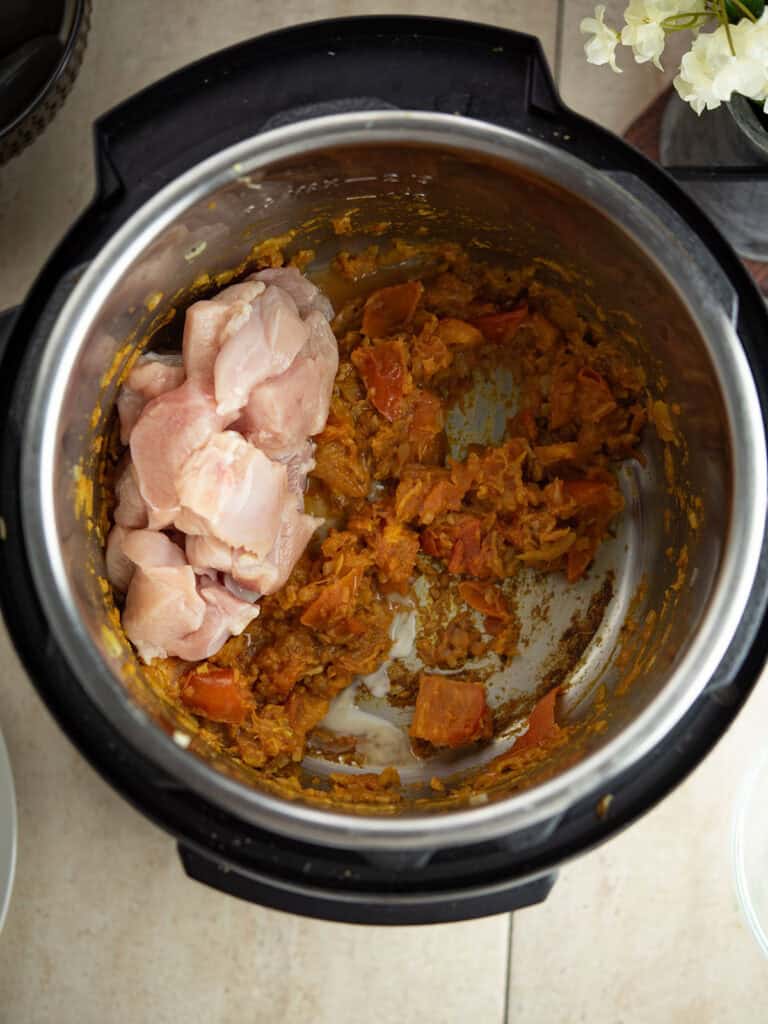 chicken is added to the curried masala in the Instant Pot
