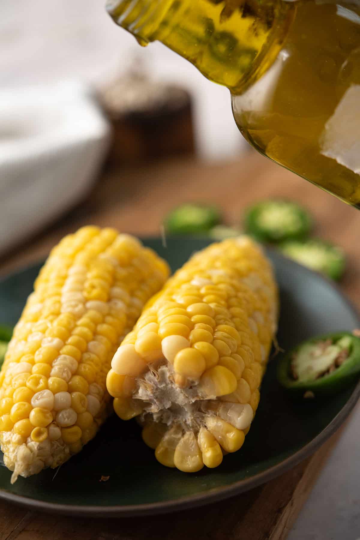 serving jalapeno infused olive oil over corn