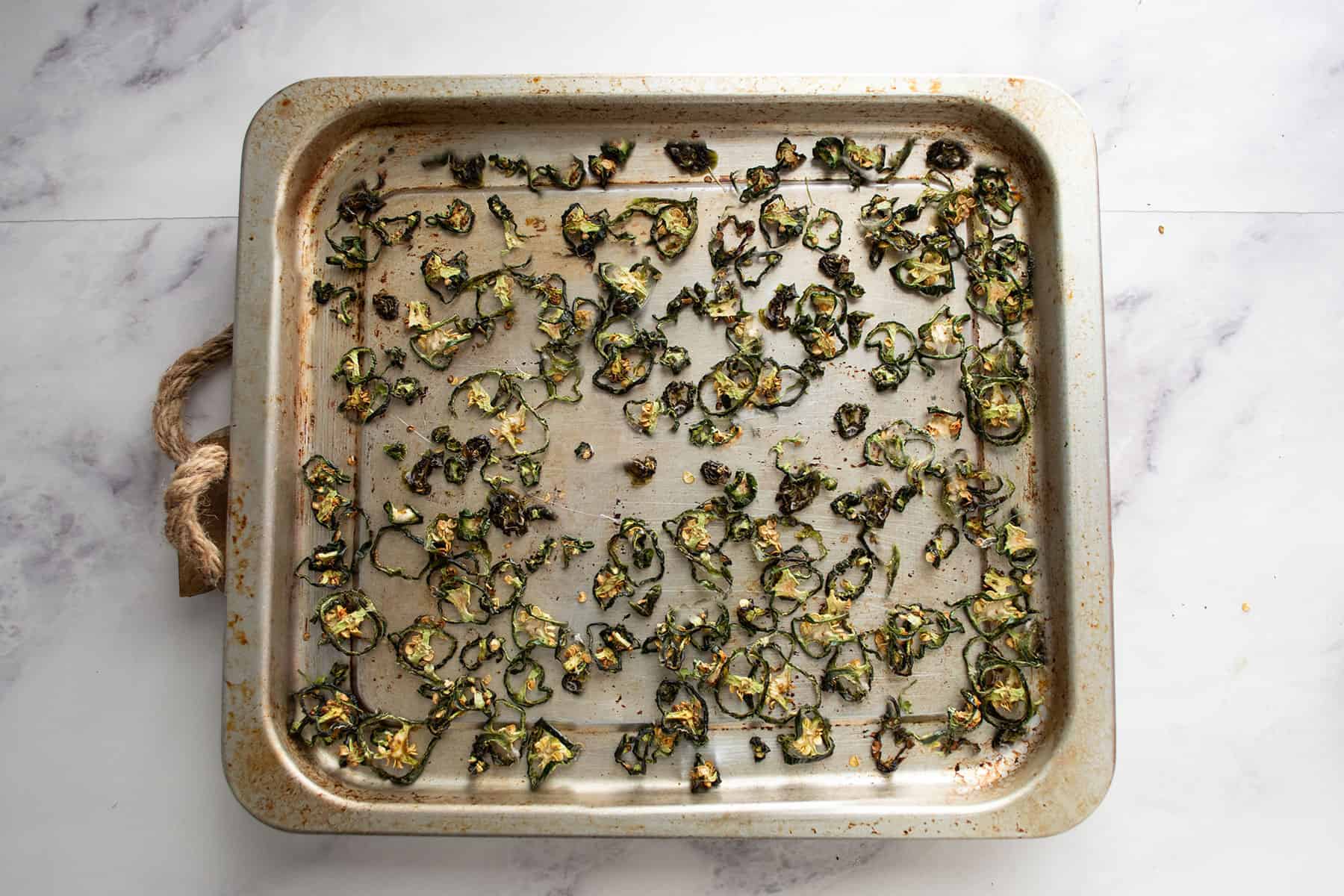 dried slices in the tray for making dried jalapeno powder