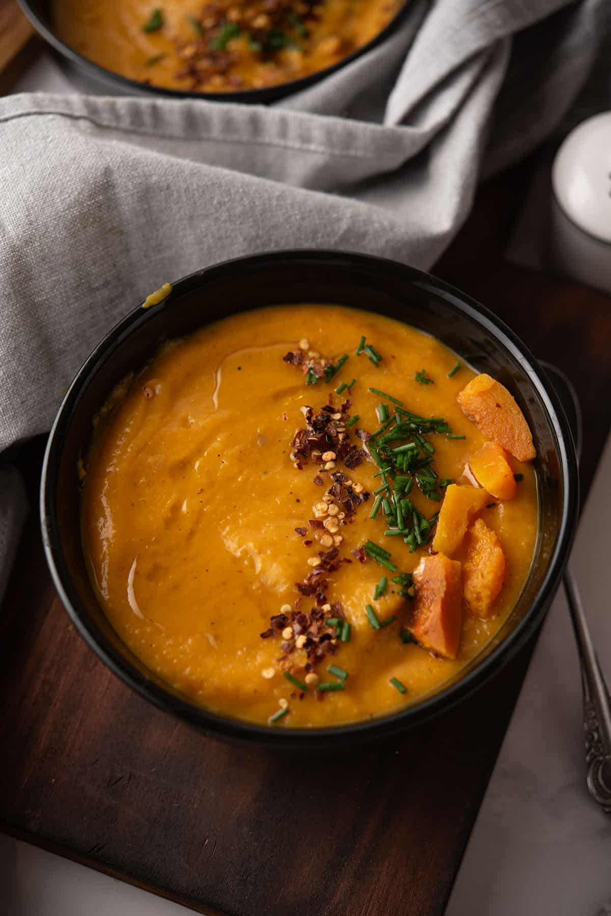 roasted spicy butternut squash soup served in a soup bowl