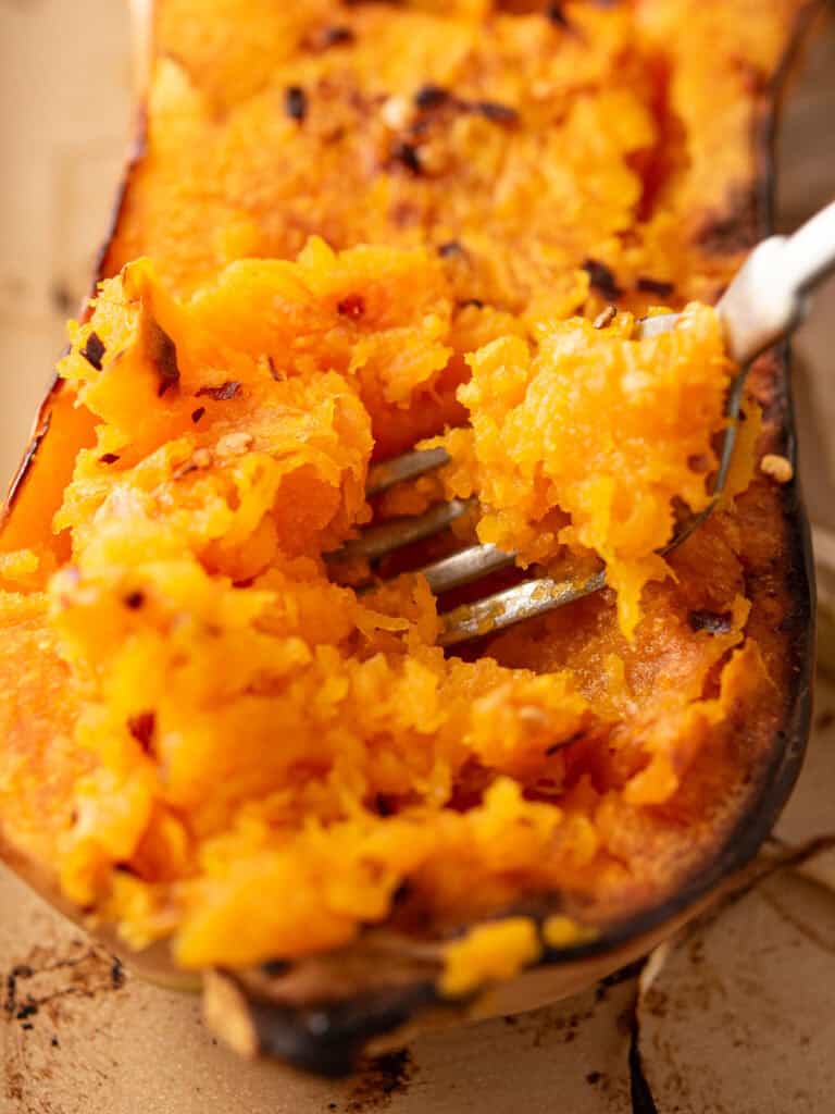 step 2 scooping the cooked butternu squash for making spicy butternut squash soup