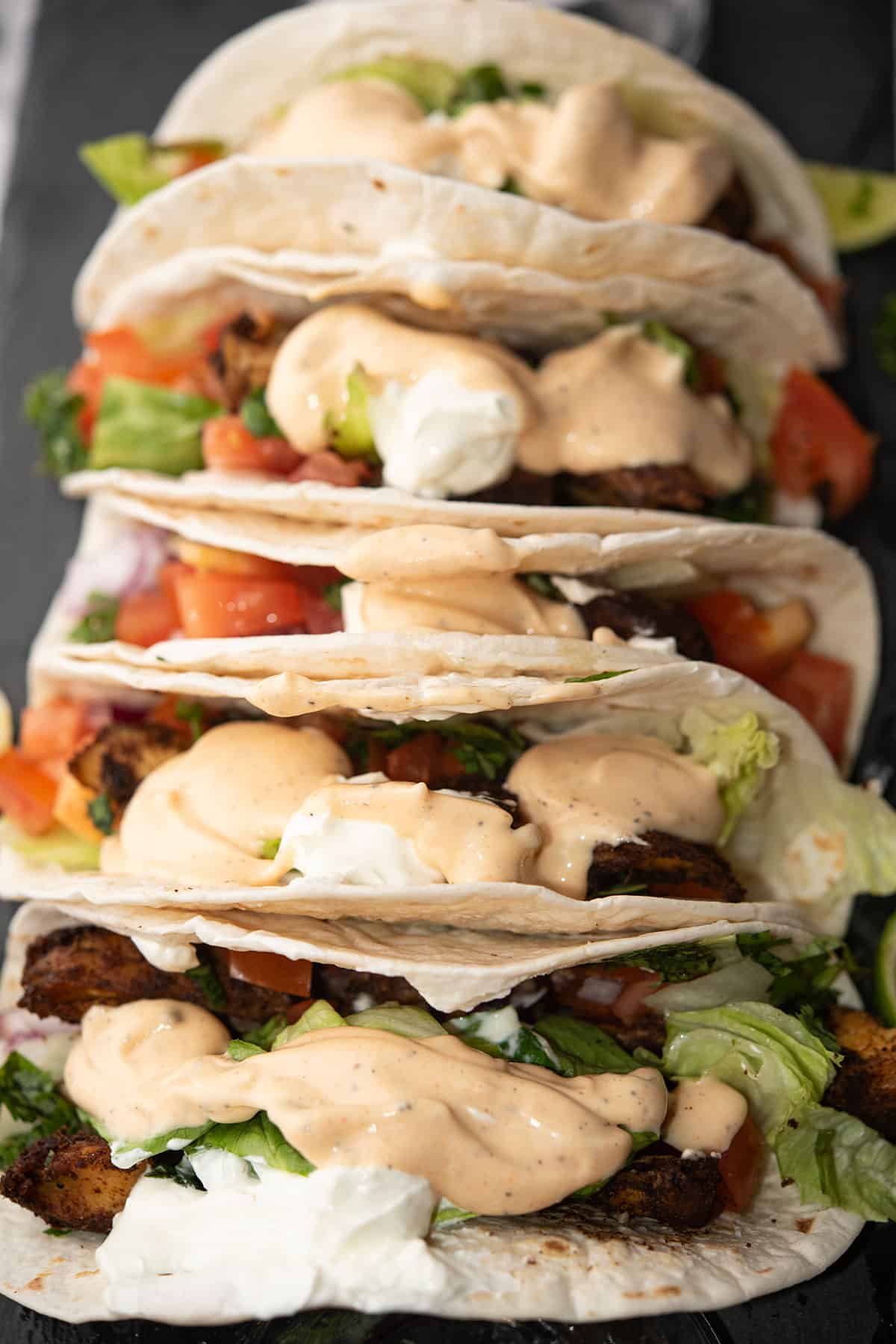 drizzled sriracha fish taco sauce over the soft tacos