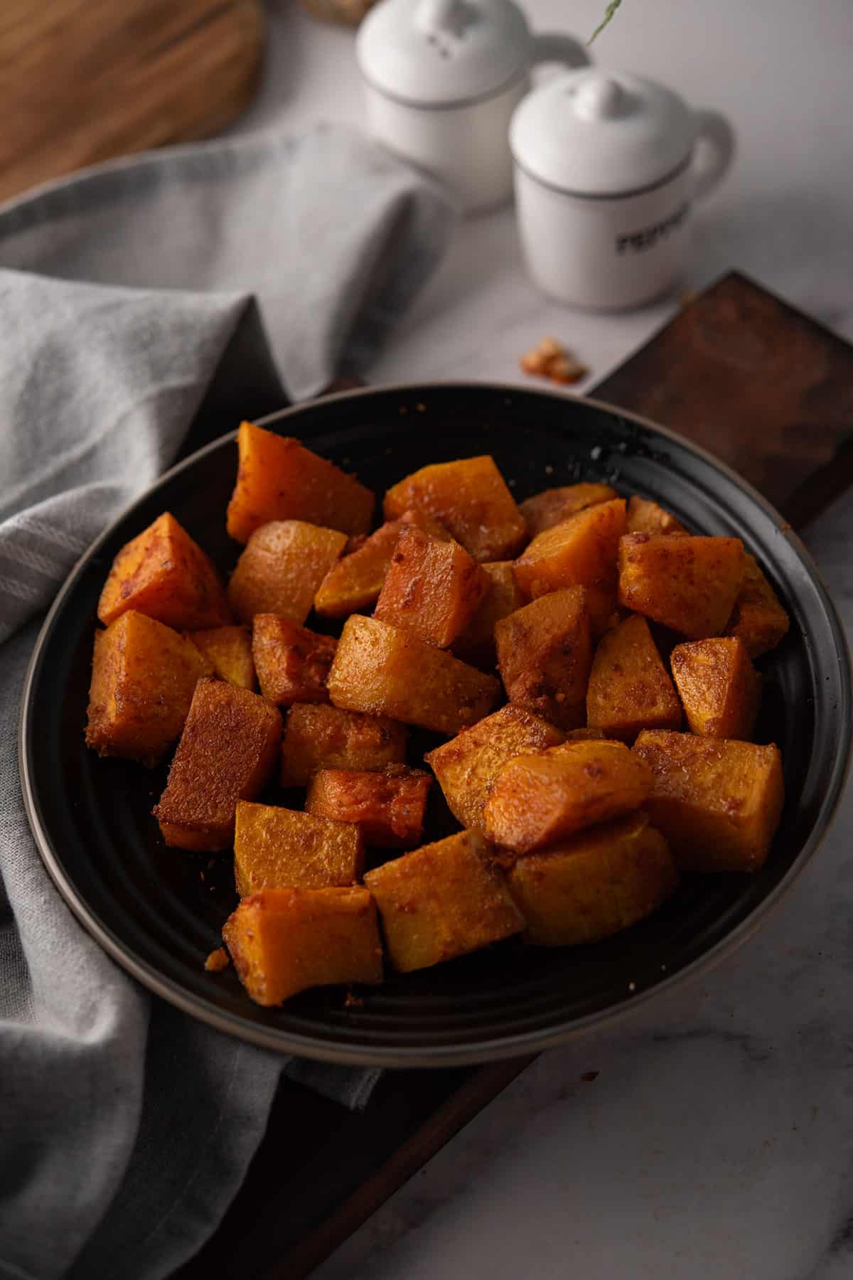spicy roasted butternut squash in a black plate