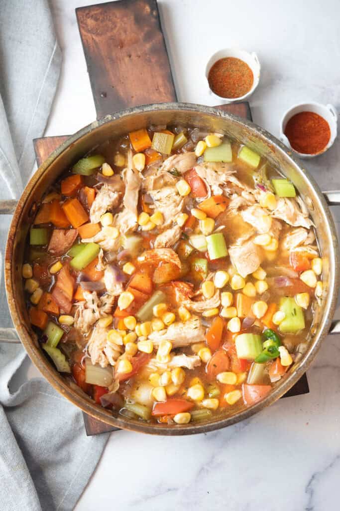 top view of the spicy chicken soup with chicken and corn kernels