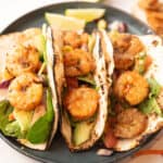 cajun shrimp tacos served in a black plate