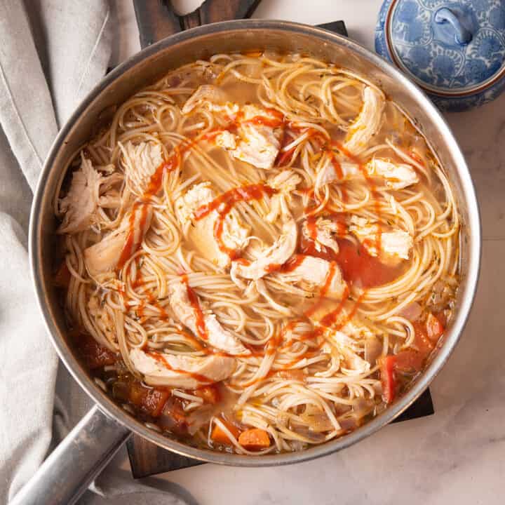 spicy chicken noodles soup in a large pan