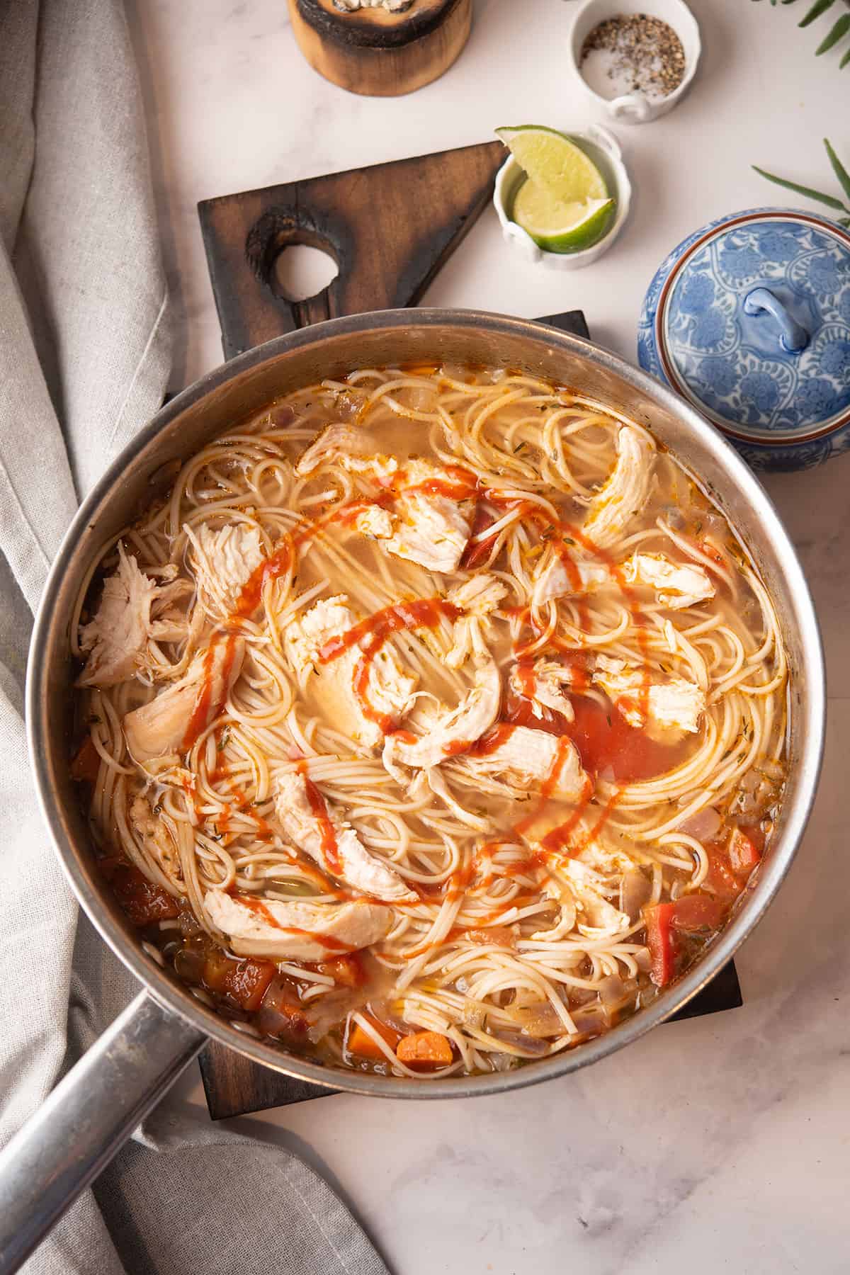 spicy chicken noodle soup served in a pan