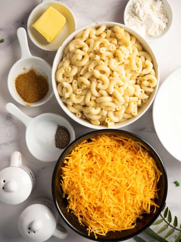 ingredients are assembled for making curry mac and cheese over counter top