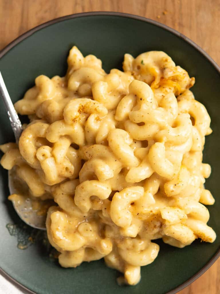 curry mac and cheese served in a plate with a spoon