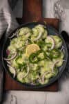 cucumber jalapeno salad with lemon and onion in a bowl