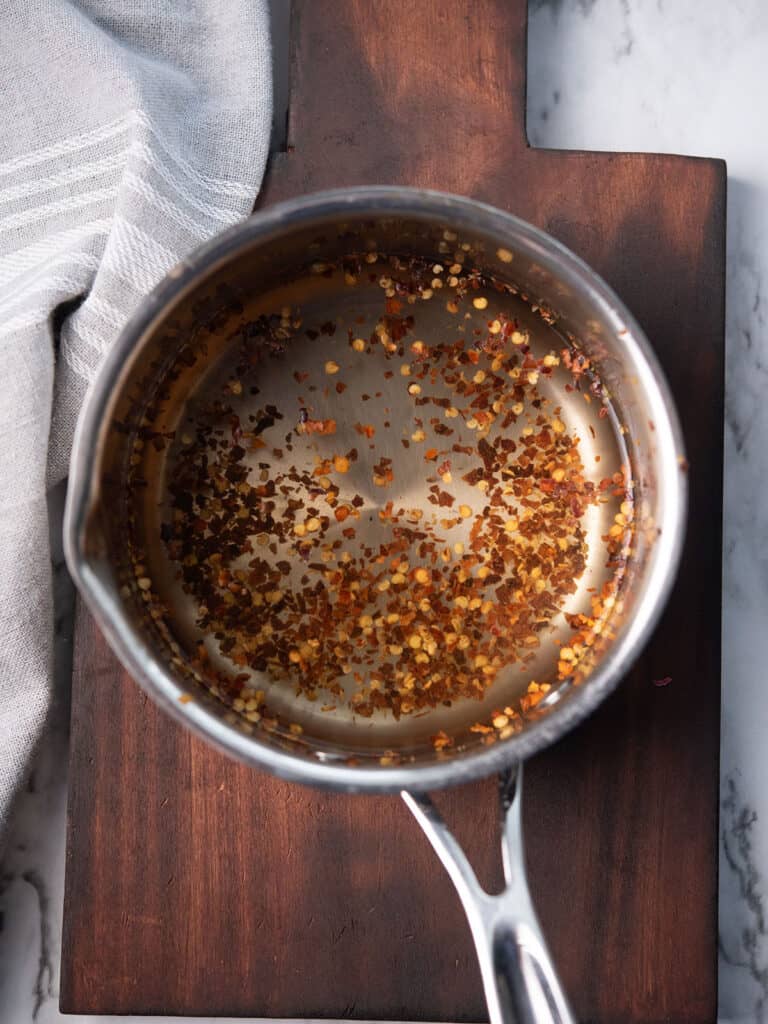 the red pepper flakes spice mix in a sauce pan