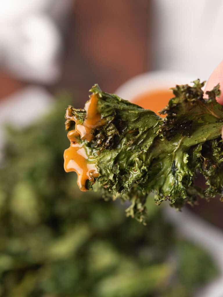 spicy kale chips are drenched in a creamy dipping sauce