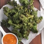 spicy kale chips served with a dipping sauce.