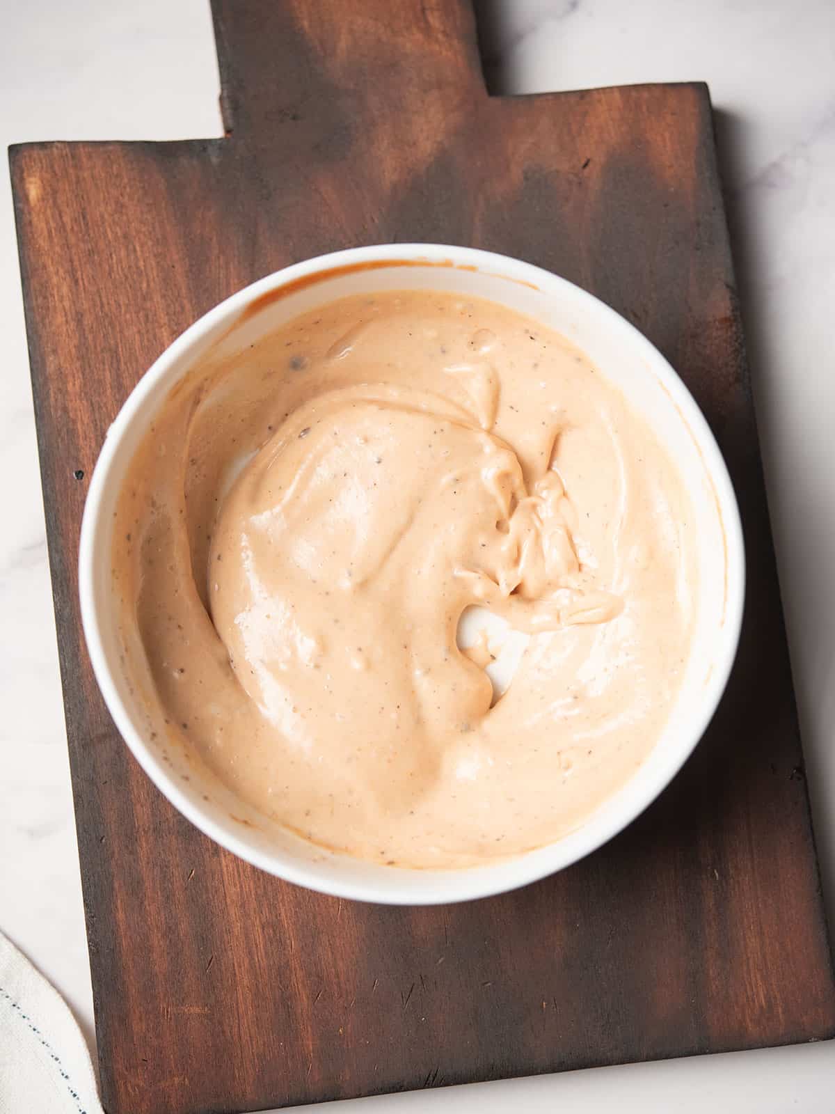Making the BBQ aioli in a bowl with whisk