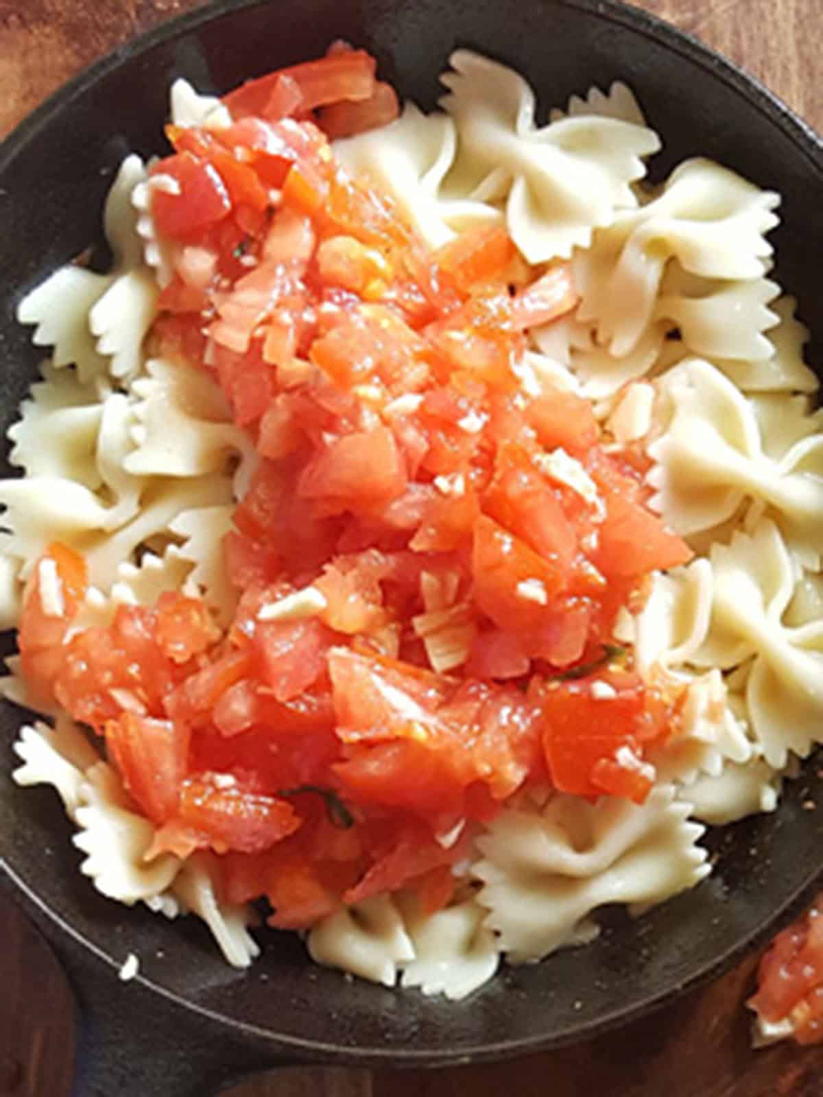 the bruschetta sauce is added to the shrimp and pasta