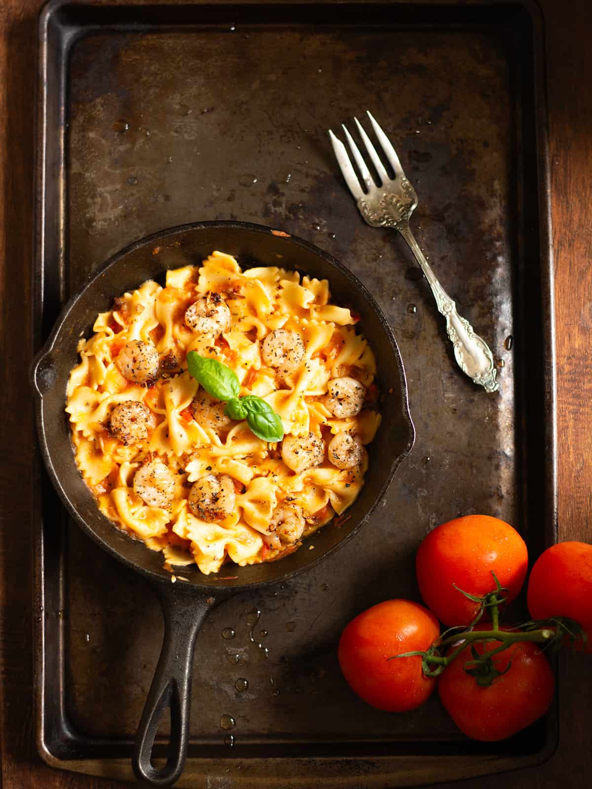 bruschetta shrimp pasta in a pan served with a fork