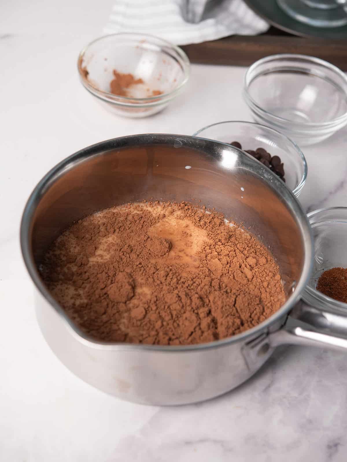 adding the ingreidents for making Cajun hot chocolate