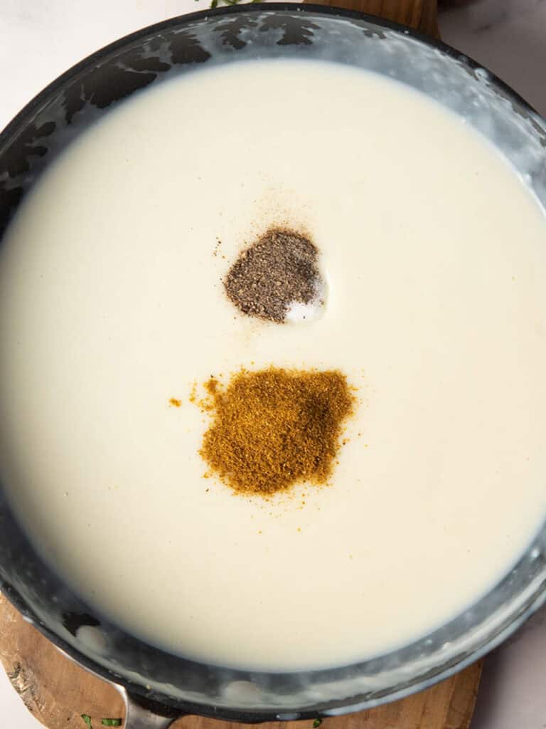 adding curry spices to make curry mac and cheese