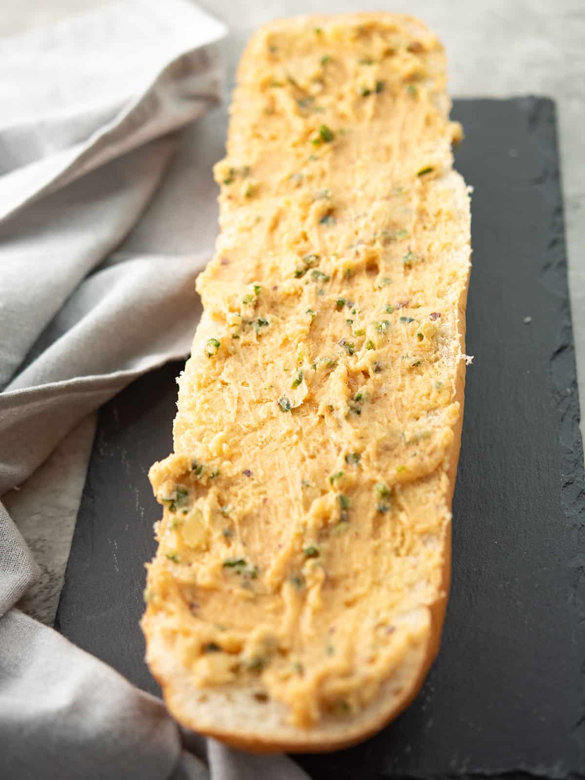 the bread load is slathered with the spice mixture for making jalapeno garlic bread
