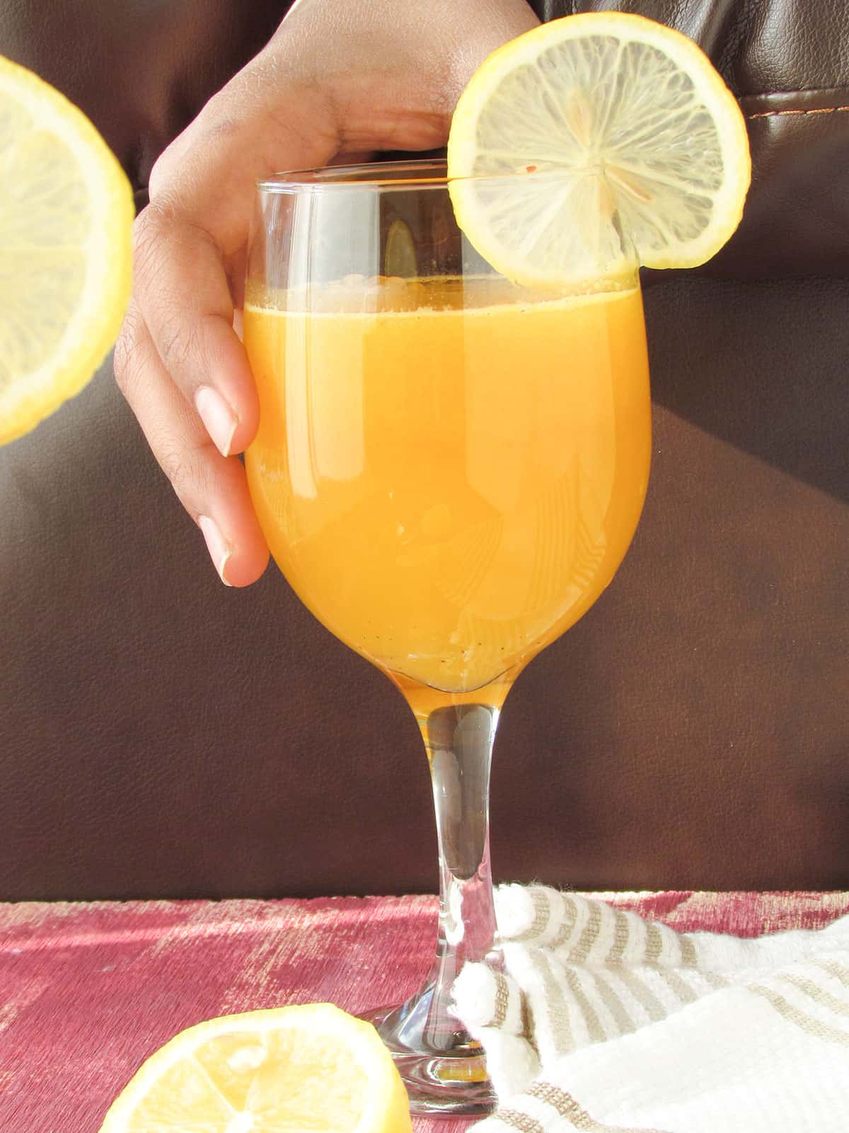 serving orange punch in the dining table with lemon wedges
