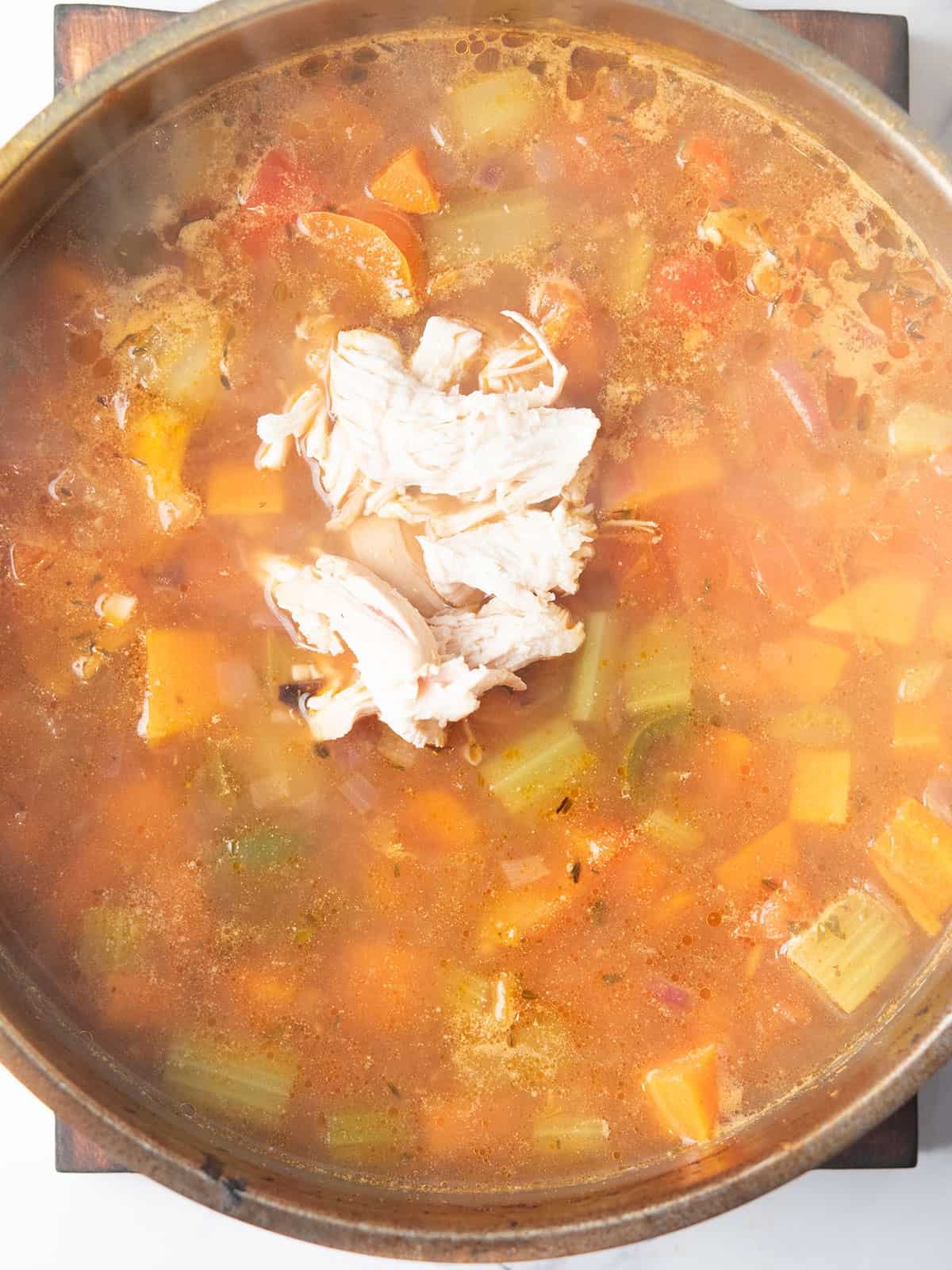 the pot with shredded chicken into the soup