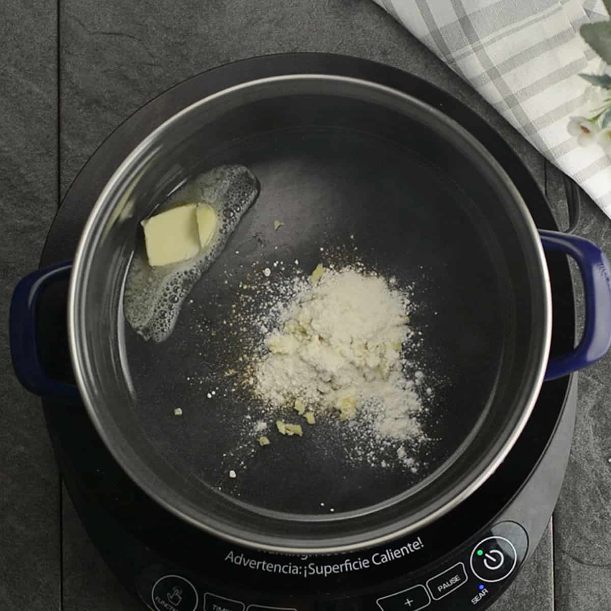Butter melting in a saucepan, the first step in making jalapeño cheese sauce.