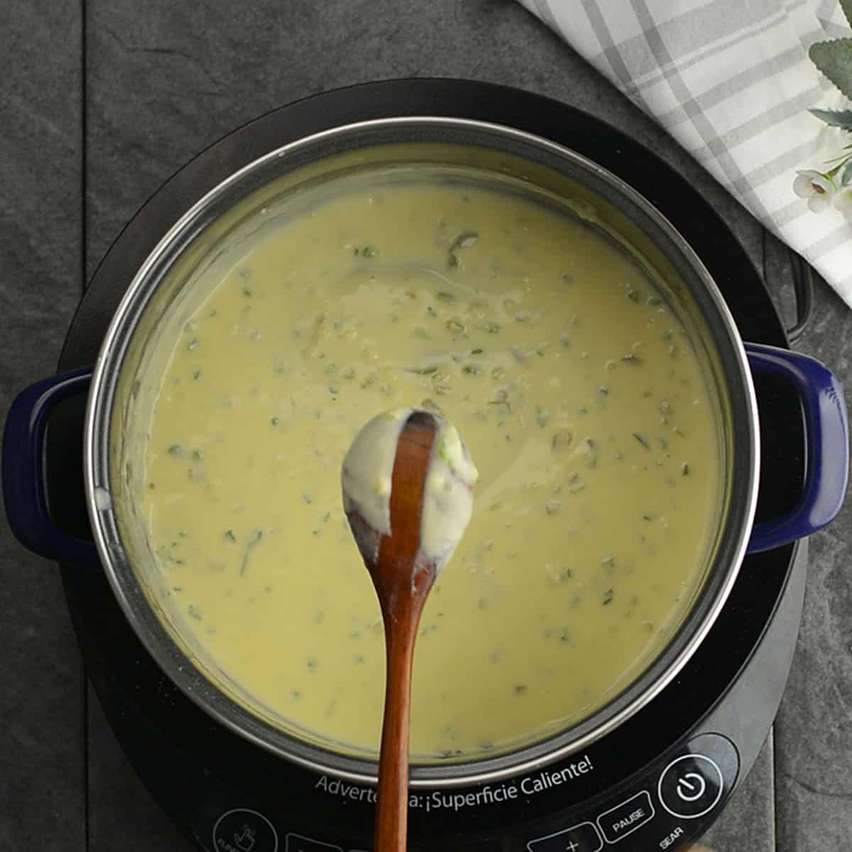 Cheese melting in a saucepan with a smooth, creamy jalapeno cheese sauce.