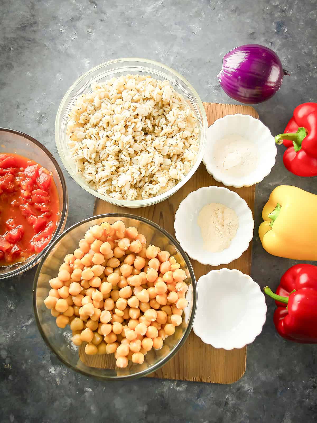 the ingredients for the barley stuffed peppers arranged in the kitchen counter