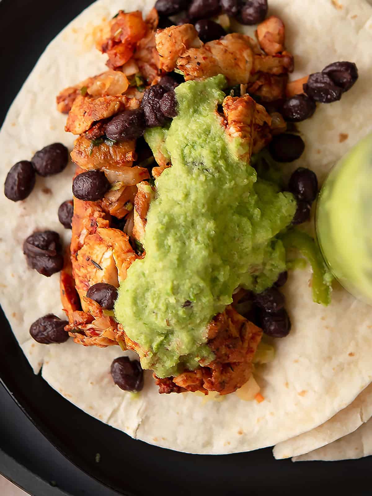 green taco sauce served over a tortilla wrap