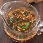 jalapeno honey sauce in a glass jar placed in the kitchen counter top